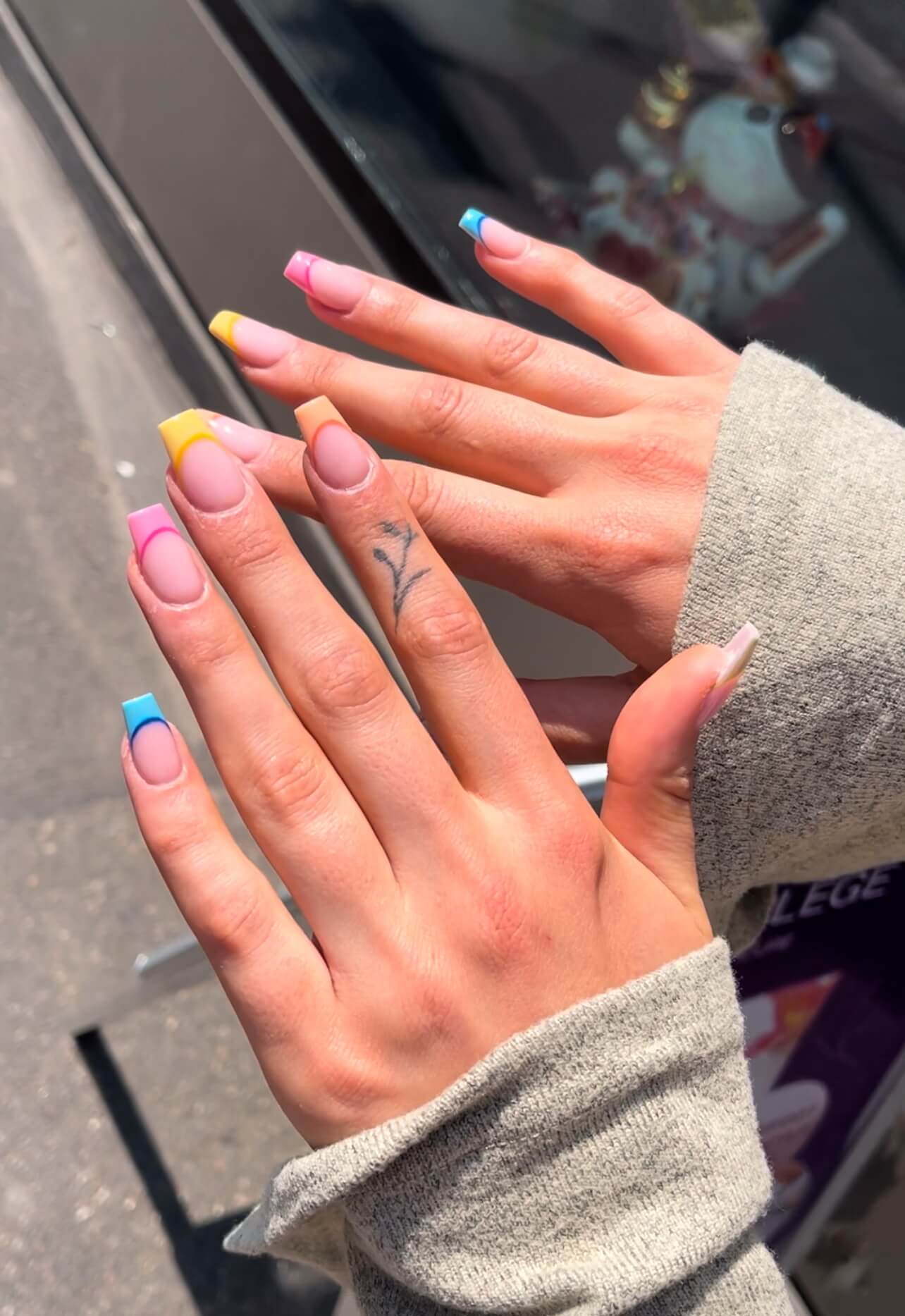 Close-up of hands with colorful long nails using acrylic nails